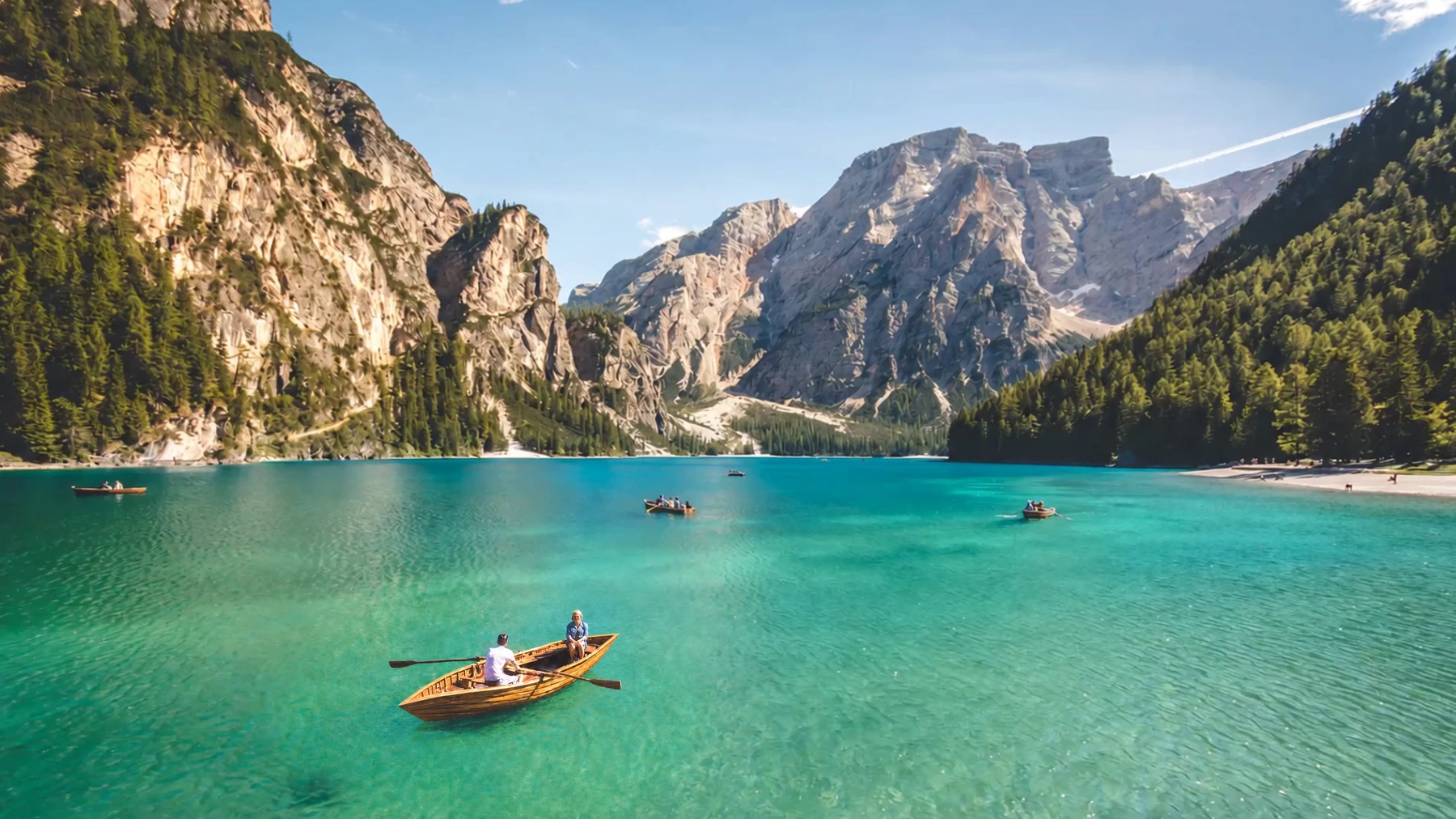 A calm turquoise lake surrounded by mountains